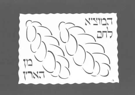 Wycinanka pokazująca dwa bochenki chlea. Obok nich napisy w języku hebrajskim.